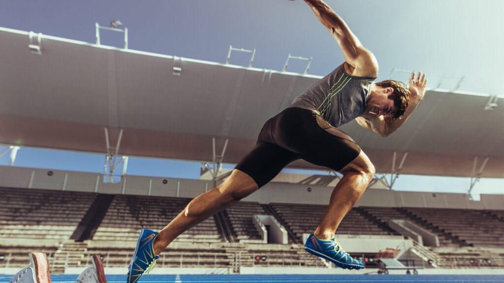 Athlete accelerating from starting blocks symbolising leadership momentum and faster strategy execution.